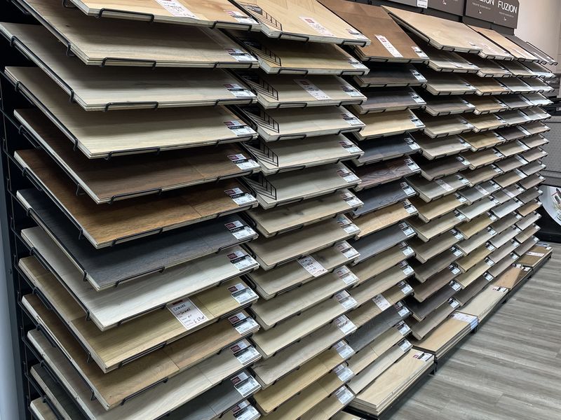 Racks of Fuzion hardwood and laminate flooring samples in the Emard showroom